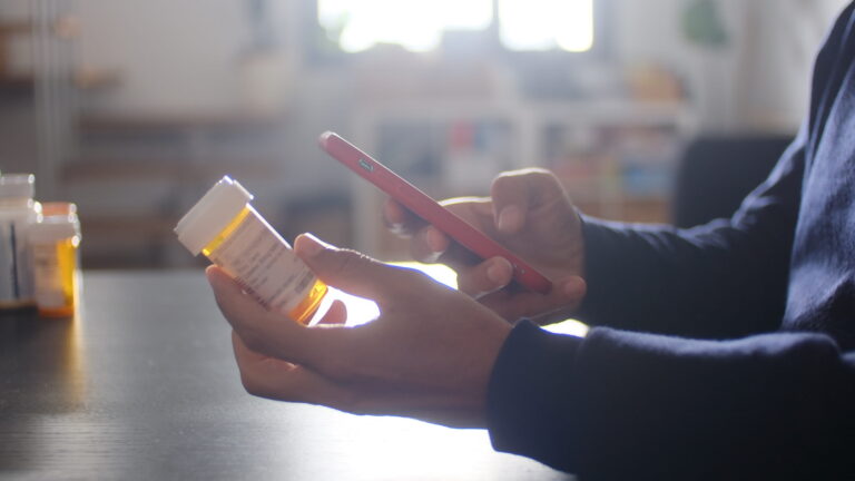 A patient using a smartphone app to refill prescription medication for chronic disease management.